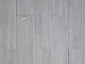 Montana Ash is a rectified porcelain tile from Spain with Wood Look on a grey background