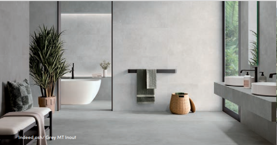 a modern bathroom designed in tones of light gray wall tiles, gray floors and brown and white accents