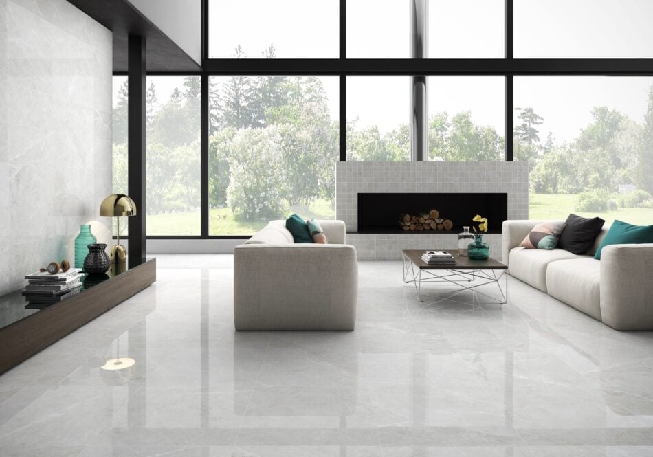 a modern living room seen with a large size square porcelain tile light gray color that looks like marble