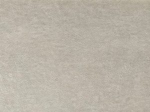 Beige wall tile with the close-up texture of real leather
