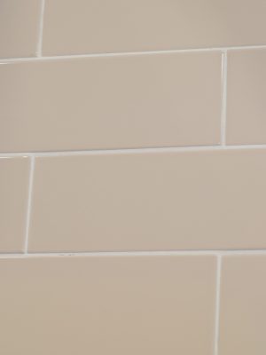 Beige color subway tile with glossy finish in the large 4x12 size