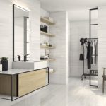 bathroom walls and floors with a 24x48 tile in of site color and subtle linear veins in warm tone, mimicking Bianco Dolomiti