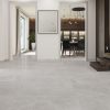 Altamura Silver 48×48 polished porcelain tile in a modern interior, reflective grey limestone look with minimal grout lines.”