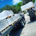 How Much Does Tile Shipping Cost? 1 tile store close to Dania Beach, unloading a truck for the warehouse