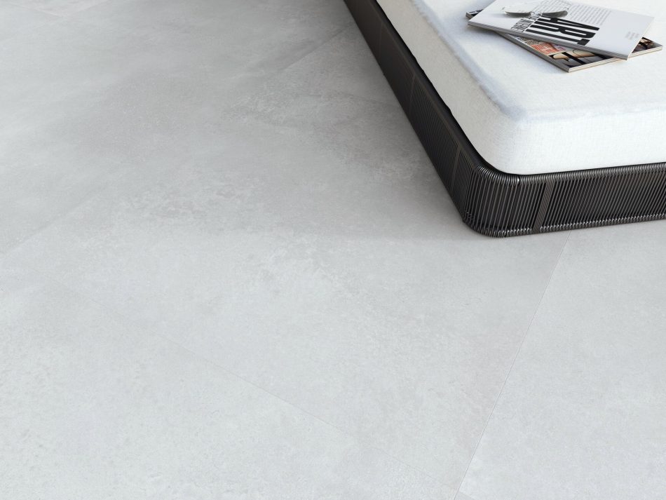 closeup picture of a light gray porcelain tile that has minimal design and looks like industrial style concrete floors.