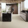 Desigless tile CD Extra White that has hand troweled resin textured in a luxurious modern kitchen with as 48x48 floor tile