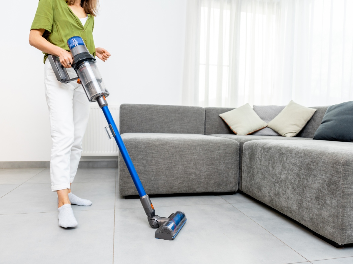 How to Clean Porcelain Tile Floors 2 Woman vacuuming living room floor tiles