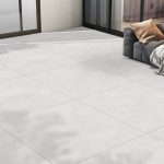 A patio with large-format concrete-look tile in a light beige color with a grey hue, offered at an affordable price