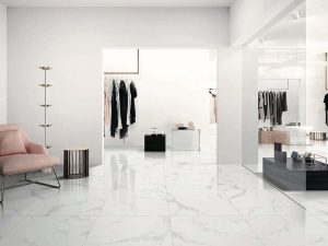 the interior of a boutique with white porcelain tile that looks like marble