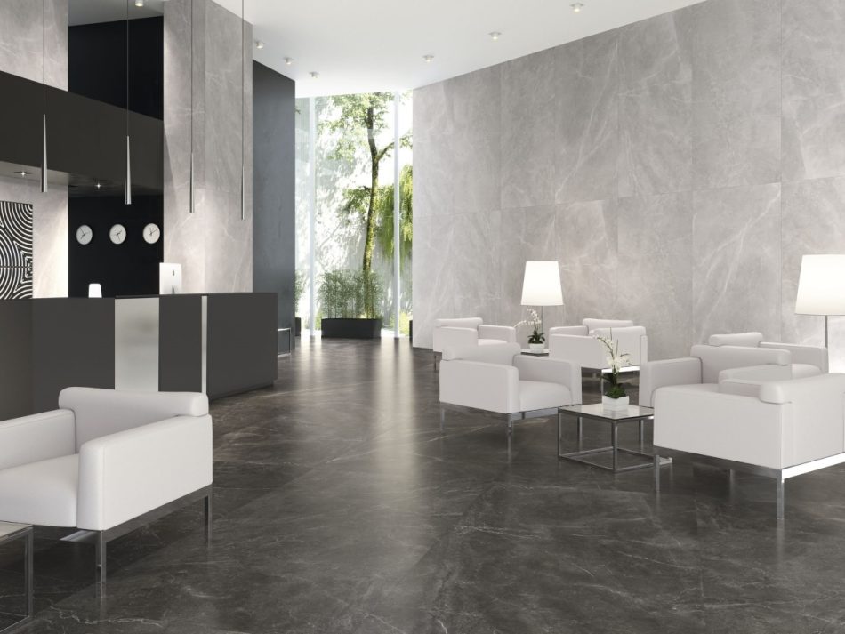 lounge with a dark color polished porcelain tile on the floor and matte finish light gray 48x48 tile on the wall.