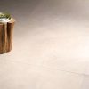close up picture of a floor with 48x48 tile that looks like limestone in very light beige color and minimal design