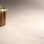 close up picture of a floor with 48x48 Tune Ivory tile that looks like limestone in light beige color and minimal design
