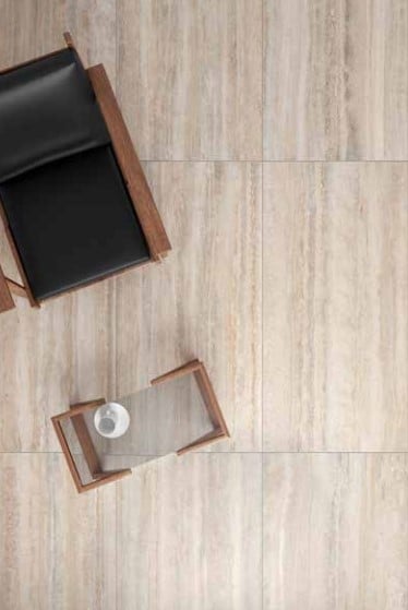 a living room floor with a vein cut travertine style porcelain tile in beige