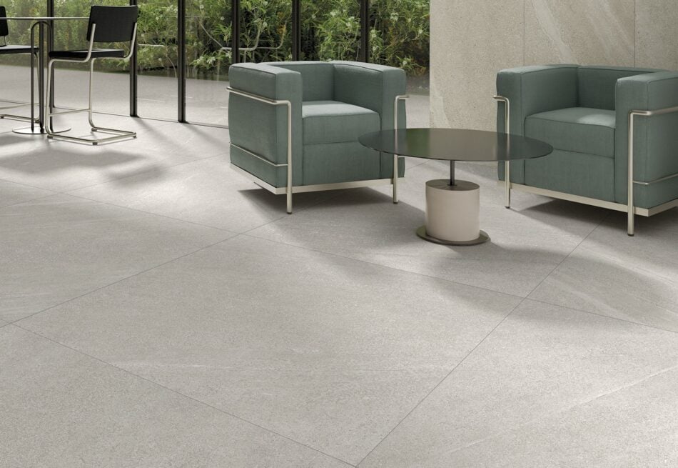 a floor with 48x48 porcelain tile that looks like a limestone in light color