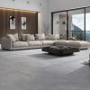 a modern living room with a mountain view that has large gray porcelain tiles in concrete style