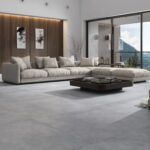 a modern living room with a mountain view that has large gray porcelain tiles in concrete style
