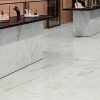 a lobby with crystalyn 63x63 tiles floors. The tile has a background like crystal and beige veining