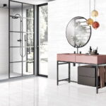 a bathrom and shower walls with a white porcelain tile that has some linear veining.