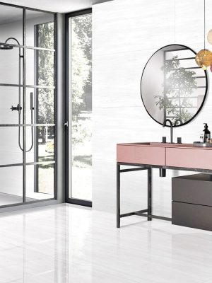 a bathrom and shower walls with a white porcelain tile that has some linear veining.