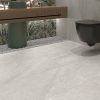 A modern bathroon floor with 24x48 Limestone White tile floor