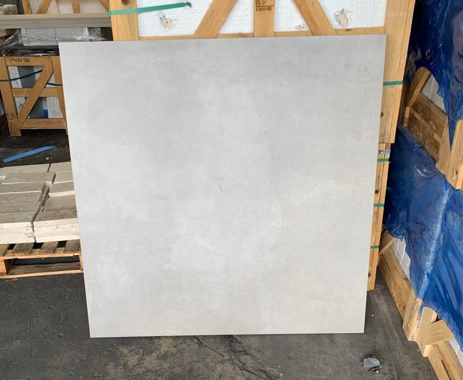 48x48 Urban Grey concrete look tile standing in TSW warehouse