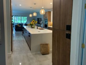 24X48 polished concrete look tile Natron Grey floor in a modern living room and kitchen