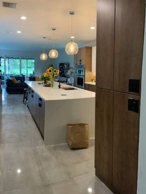 24X48 polished concrete look tile Natron Grey floor in a modern living room and kitchen
