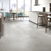 Urban Grey large format concrete look tile in a modern condo living room and kitchen area.