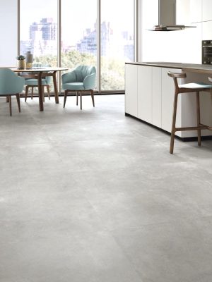 Urban Grey large format concrete look tile in a modern condo living room and kitchen area.
