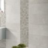 Atelier Lux Grey: 24x48 concrete look tile in on a bathroom wall