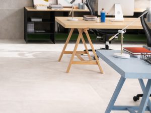 Atelier Lux 24x48 porcelain tile in commercial studio, white floor and grey wall