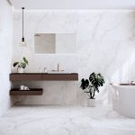 Seamless floors and walls in a white bathroom with warm white 63x63 matte porcelain tile and minimal veining