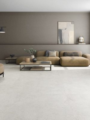 Concrete look tile in the large format 63x63 size in a modern living room that looks seamless