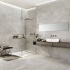 a modern bathroom and shower with a 48x48 polished porcelain that looks like a limestone in light gray