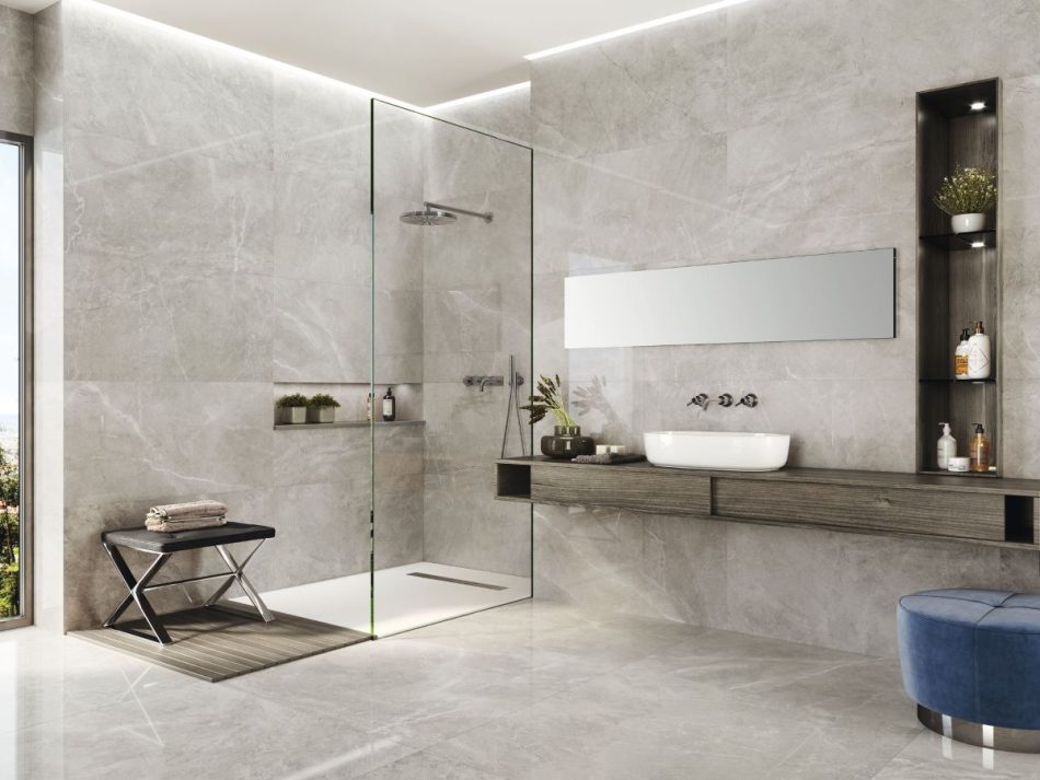 a modern bathroom and shower with a 48x48 polished porcelain that looks like a limestone in light gray
