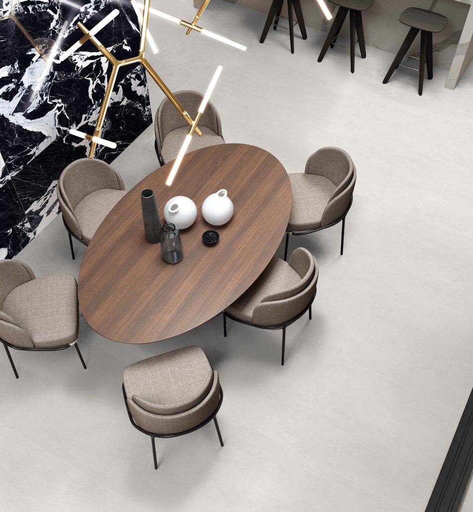 Soft Cement White, subtle concrete look tile in a living and dining room.