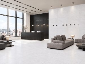 48x48 Tune Snow limestone look tile in a commercial space has subtle movement and light tones with grey hue