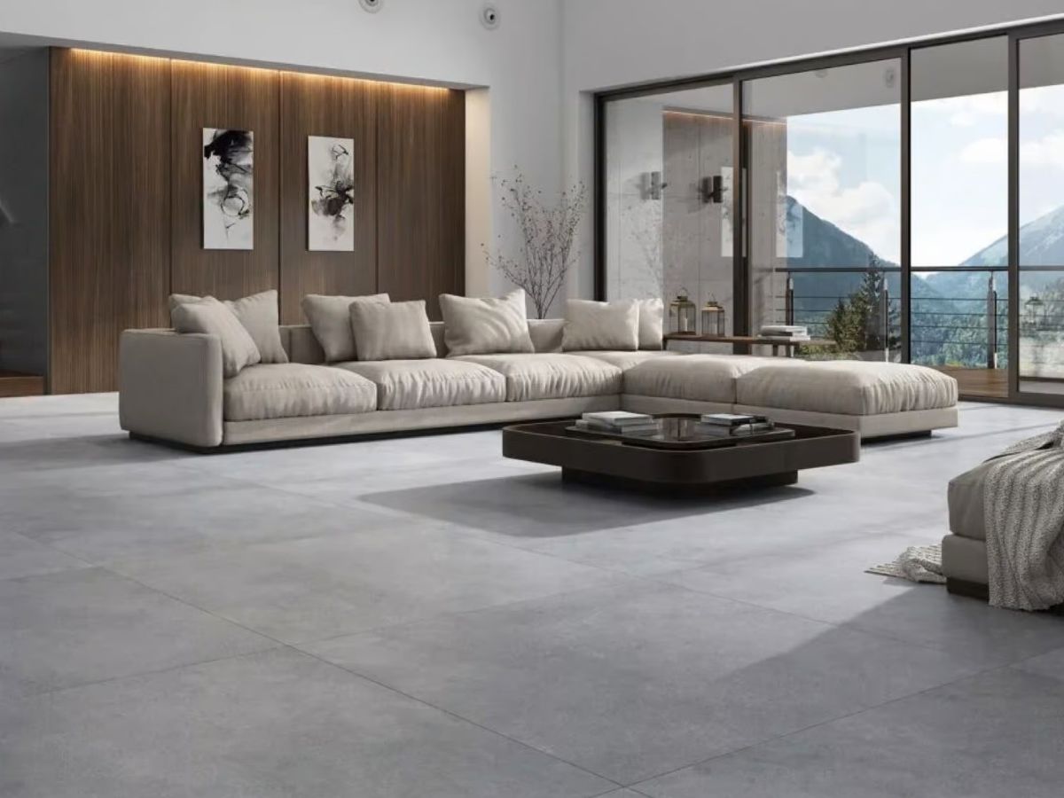 the picture showing a modern living room where the floor looks seamless with 48x48 size tile gray concrete concrete look tile