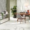 pictures showing graphic details of Statuario White Italian tile under a dining table