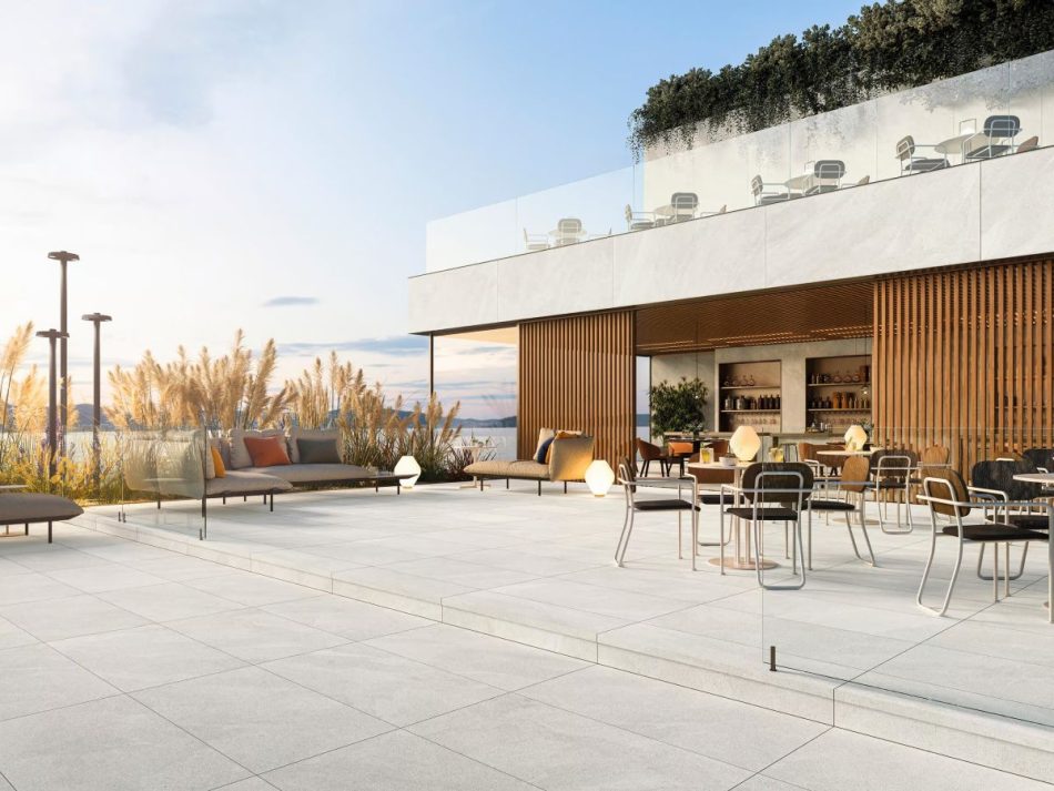 Outdoor patio with Tune Snow light grey limestone look porcelain tile in 24×48 size