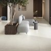 Large format 48x48 porcelain tile floor with minimal grout lines in a modern interior