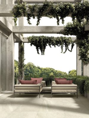 an elegant patio with 48x48 limestone beige in & out tile