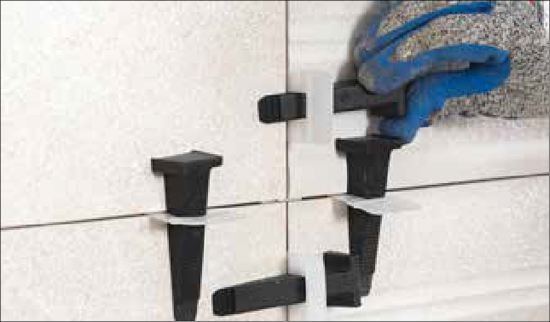 Ceramic and Porcelain Tile Installation Guide 53 levelling clips on a wall tile installatiom