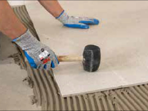 Ceramic and Porcelain Tile Installation Guide 1 tapping-on-the-the-tile-to-prevents-holes-between-the-tile-and-floor.png