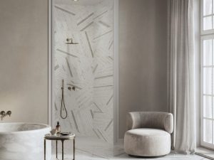 Contemporary bathroom featuring Intarsi Tiziano 24x48 large-format porcelain flooring and shower walls with a directional geometric aesthetic.